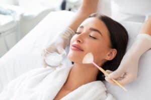 Woman relaxing while receiving her chemical peel treatment in Bellevue, WA